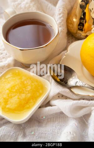 Lemon and green tea in white cup, fresh healthy detox tea, vertical image Stock Photo
