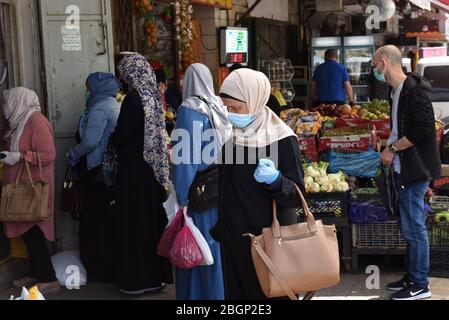 East Jerusalem, Israel. 22nd Apr, 2020. Palestinians wear masks, as a preventative measure, against the spread of the coronavirus, while shopping for the Muslim holy month of Ramadan, on Wednesday, April 22, 2020, in East Jerusalem. Muslim clerics have announced the Al Aqsa Mosque will remained closed for the holy month which begins Thursday evening. Photo by Debbie Hill/UPI Credit: UPI/Alamy Live News Stock Photo
