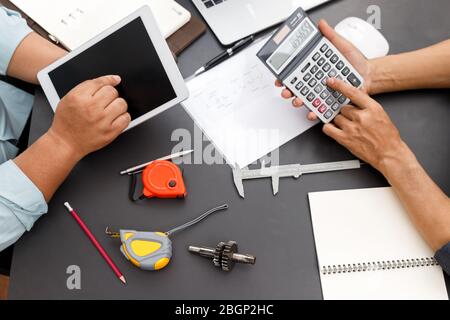 The engineering team is working on their project together. Stock Photo