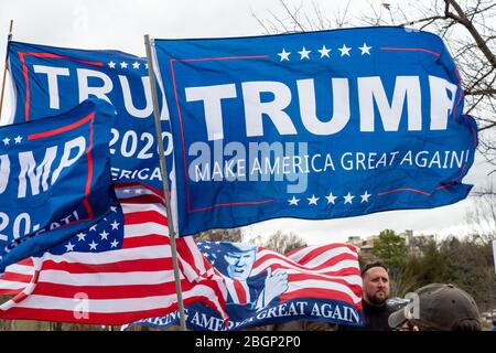 CHARLOTTE, NORTH CAROLINA/USA - February 7, 2020: Trump flags fliy in the stiff wind awaiting Presdient Donald Trump's visit to Charlotte, NC Stock Photo