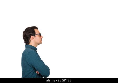 Side view of pensive young businessman keeps arms crossed, looking thoughtful ahead, isolated over white background with copy space. Serious emotion b Stock Photo