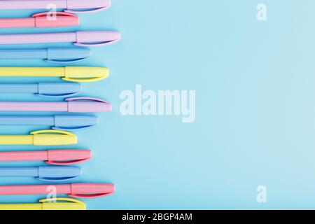 Multi-colored markers on a blue background with free space. Stock Photo