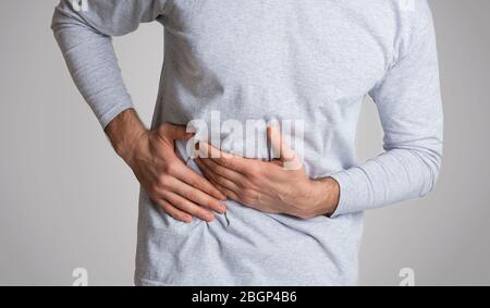 Cirrhosis of liver. Man holding hand in area liver Stock Photo