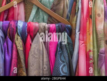 Background of colourful scarfs hanged in a store display Stock Photo