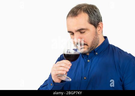 man smelling a glass of wine on white background Stock Photo