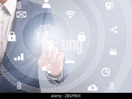 Business man in suit pressing button on infographic panel Stock Photo