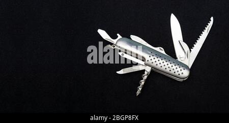 Close up photo of swiss army knife on black background with copy space Stock Photo