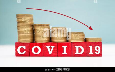 World Economies sinking down due to coronavirus pandemic shows with coins Stock Photo