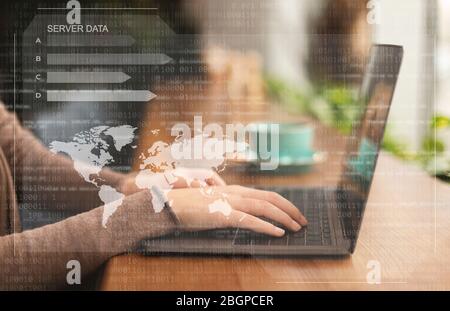 Female hacker using laptop looking at database server Stock Photo
