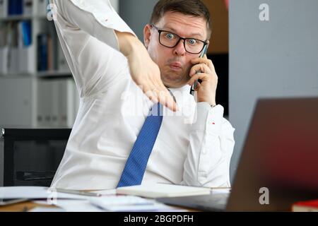 Male executive talking cellphone about bad consequences Stock Photo