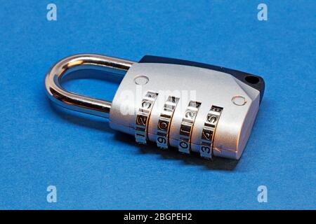 a padlock with combination on blue background Stock Photo