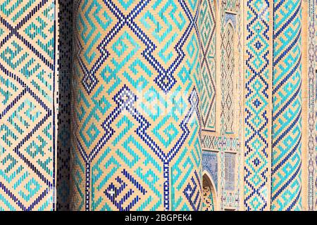 Close view of majolica and ceramic tiles in Ulugh Beg Madrasah (Islamic school). Located in the Registan Square, Samarkand, Uzbekistan. Blue and cyan. Stock Photo