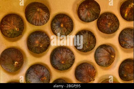 Top view of fresh fig fruits on an organic packaging for sale at market. Stock Photo