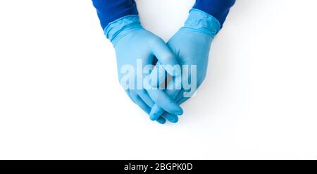 Blue Nitrile gloves banner. Hands of a medic in the blue latex gloves on white table Stock Photo