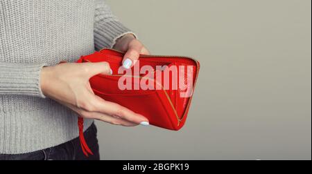 Close up of woman hands open an empty wallet.  Stock Photo
