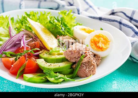 Healthy food. Tuna fish salad with eggs, lettuce, cherry tomatoes, avocado and red onions.  French cuisine. Stock Photo
