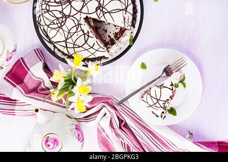 Chocolate cake with cherries and  cream on light background. Top view, overhead Stock Photo
