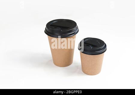 Craft coffee cups with paper on bright background. Eco friendly design. Zero waste, plastic free items Stock Photo