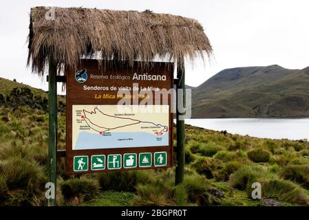 The visitor information sign showing paths and trails at the entrance to the Antisana Ecological Reserve high up in the Andes mountain range, Ecuador Stock Photo