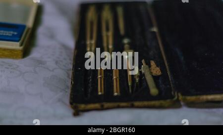set of old drawing compasses in a package Stock Photo