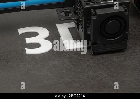 3D printer prints the word 3D with white filament PLA Stock Photo