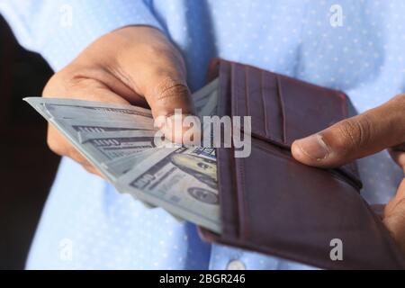 Close up of person taking money out from wallet  Stock Photo