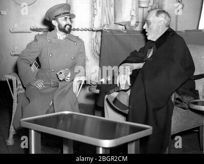 Emperor Haile Selassie I (1892-1975) of Ethiopia, Africa, meets with US President Franklin D. Roosevelt (1882-1945) aboard the Navy ship USS Quincy, in the Suez Canal. They met during WW II, on February 13, 1945, just after the Yalta Conference.  When younger, Selassie was a Crown Prince, then King and Regent, then Emperor from 1930 to 1974. He was assassinated in 1975.  To see my other WW II-related images, Search:  Prestor  vintage   WW II  African
