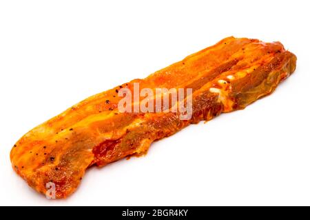 Pork bacon marinated in garlic and chilli on a white background. Stock Photo