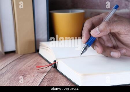 close up of businessman hand writing on notepad. Stock Photo