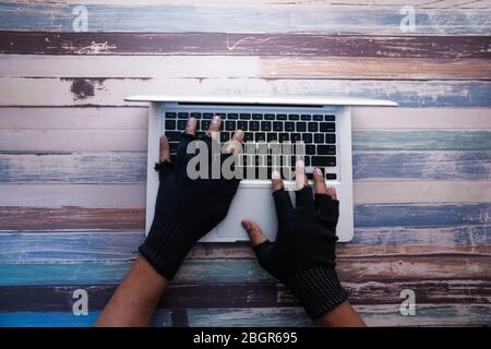 high angle view of hacker hand stealing data from laptop  Stock Photo
