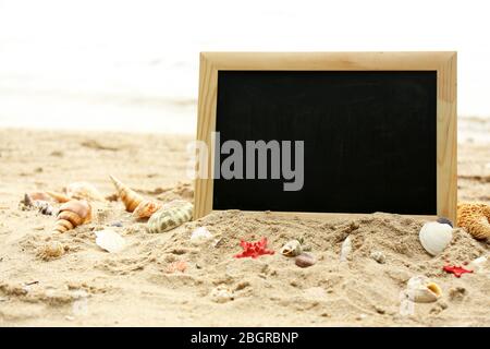 Blank chalkboard on beach background Stock Photo