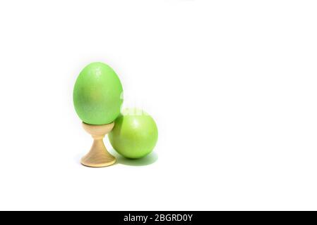 Two colored easter chicken eggs isolated on the white background. One is in holder. Stock Photo