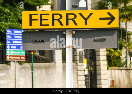CADENABBIA, LAKE COMO - JUNE 2019: Sign pointing to the car ferry dock in Cadenabbia on Lake Como. Stock Photo