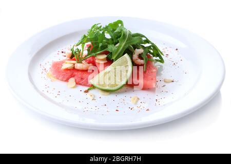 Salad with watermelon, feta, arugula, shrimps, balsamic sauce  on plate, isolated on white Stock Photo