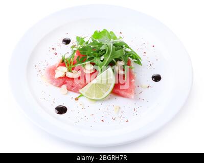 Salad with watermelon, feta, arugula, shrimps, balsamic sauce  on plate, isolated on white Stock Photo