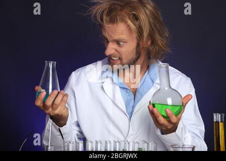 Crazy scientist working in laboratory Stock Photo