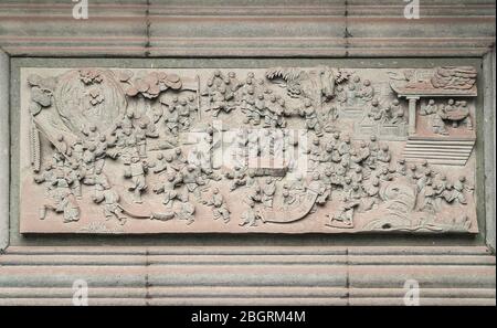 Fengdu, China - May 8, 2010: Ghost City, historic sanctuary. Gray cement fresco whereon many people congregate and discuss. Stock Photo