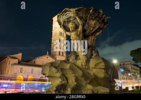 Italy, Rome, Fountain of tritons and the church of Santa Maria in Cosmedin.