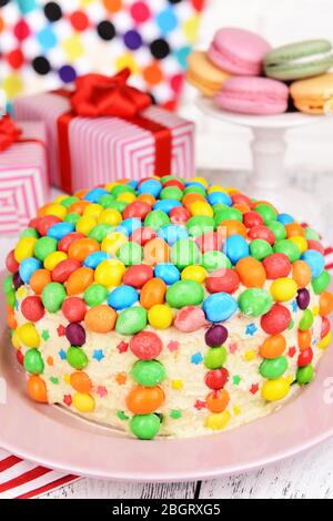 Delicious rainbow cake on plate on table on bright background Stock Photo