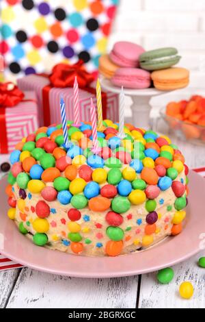 Delicious rainbow cake on plate on table on bright background Stock Photo