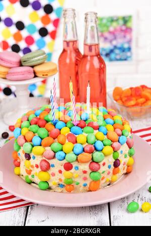 Delicious rainbow cake on plate on table on bright background Stock Photo