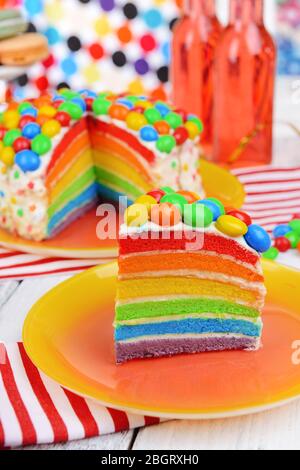 Delicious rainbow cake on plate on table on bright background Stock Photo