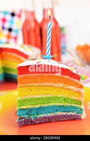 Delicious rainbow cake on plate on table on bright background Stock Photo