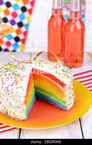 Delicious rainbow cake on plate on table on bright background Stock Photo