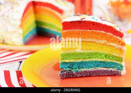 Delicious rainbow cake on plate on table on bright background Stock Photo