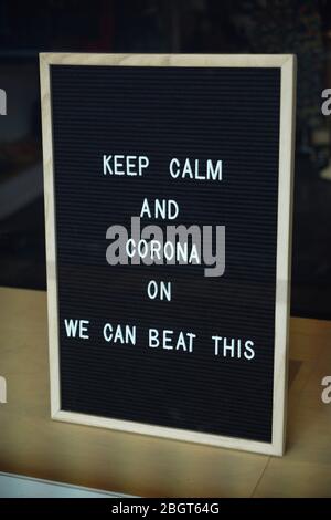 Adult and child face masks in stock hand written signs in a pharmacy window during the coronavirus covid-19 lockdown. Stock Photo