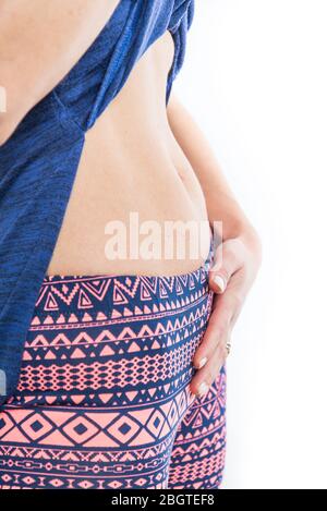 Bloated stomach. Woman touching her bloated stomach, isolated on a white background Stock Photo