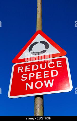 Road signs, Roundabout and Reduce Speed Now, London, UK Stock Photo