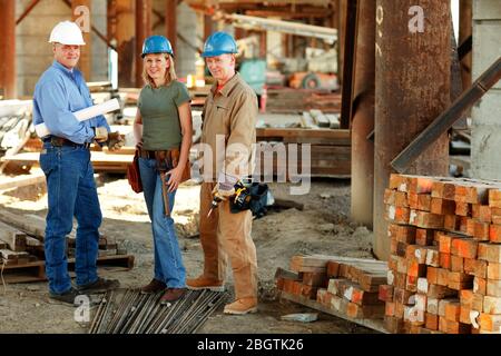 group of construction workers looking at camera on construction site Stock Photo