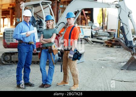 group of construction workers looking at camera standing in fron Stock Photo